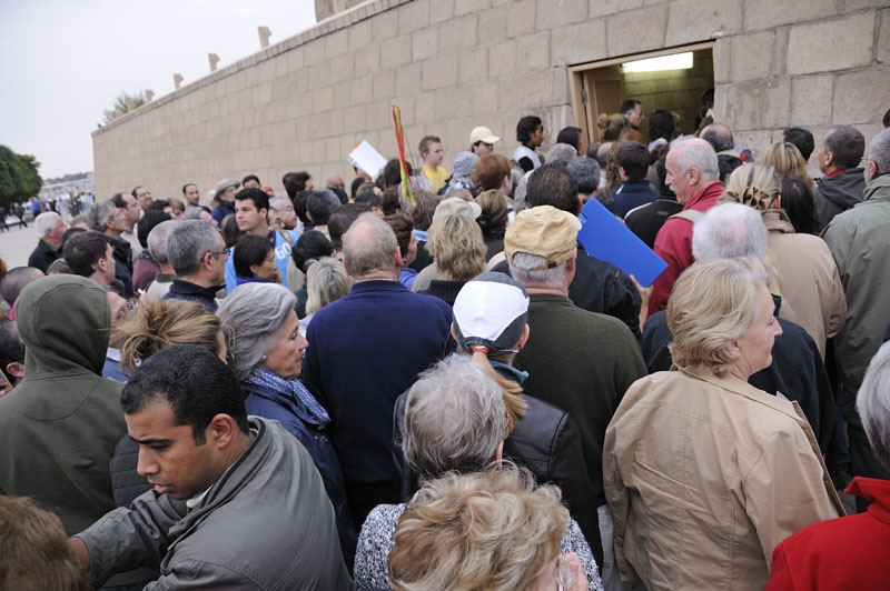 Squeezing through entrance as Temple of Kom Ombo opens