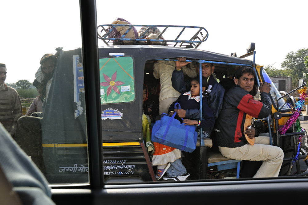 At least 15 people being transported by this auto rickshaw