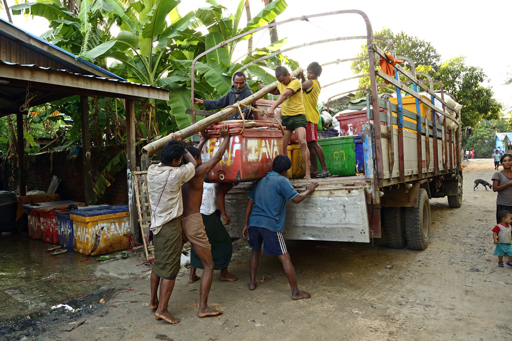 Loading heavy box of fish onto truck (3 of 3)