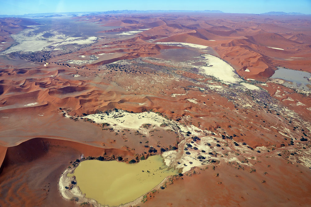 Sossusvlei Lake and its salt pan in foreground, dunes behind