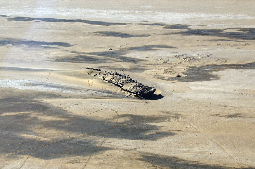 Shipwreck on the Skeleton Coast in the sand
