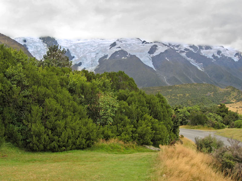 Glaciers Descending from Behind the Clouds into the Valley