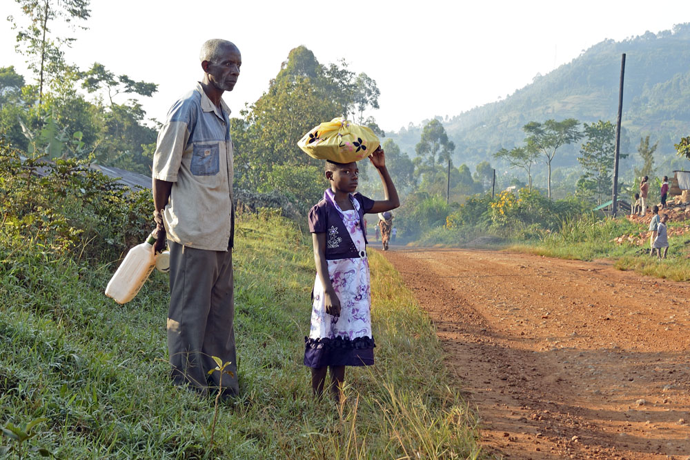 Young girl carrying goods and old man