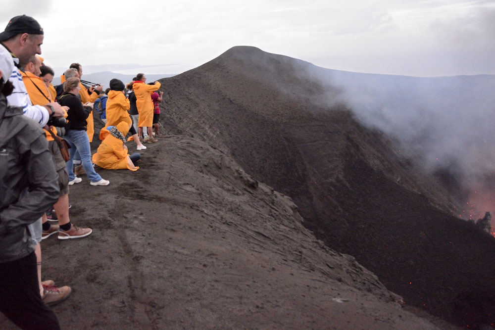 Spectators viewing eruptions stay behind the line drawn in the ash